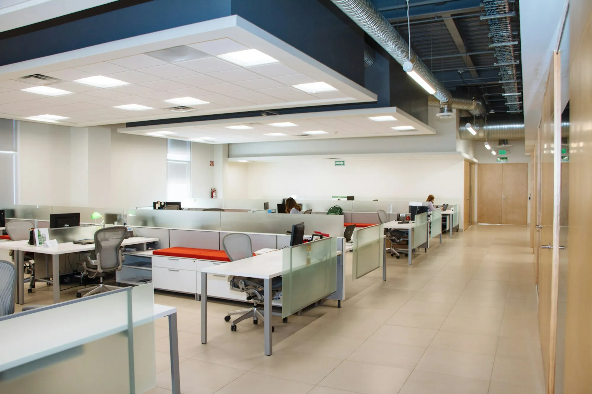 Open-plan office with rows of tidy workstations