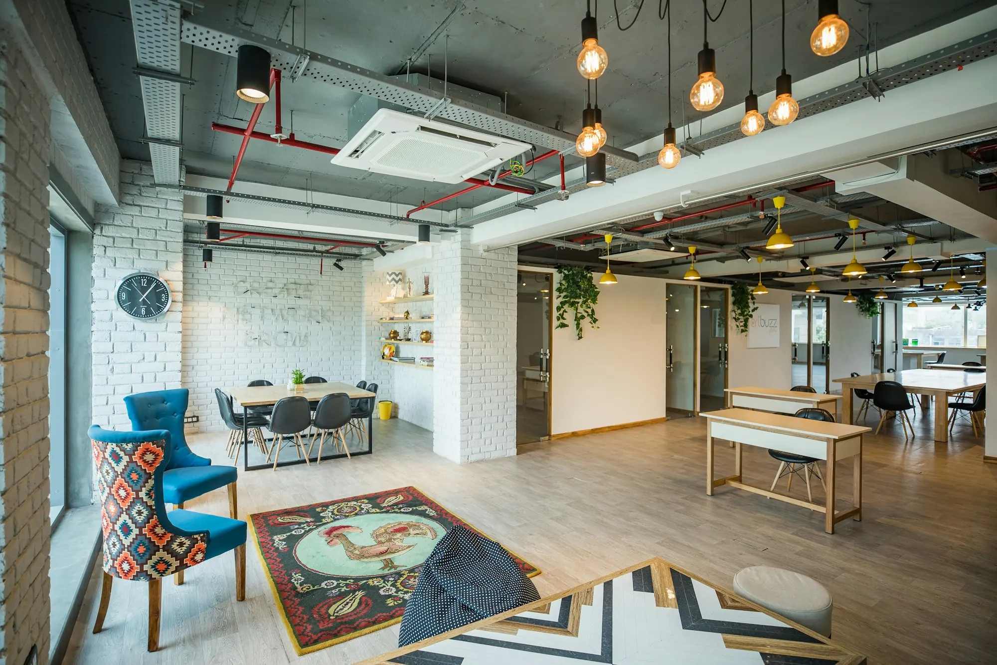 Open office with blue chairs and exposed ceilings