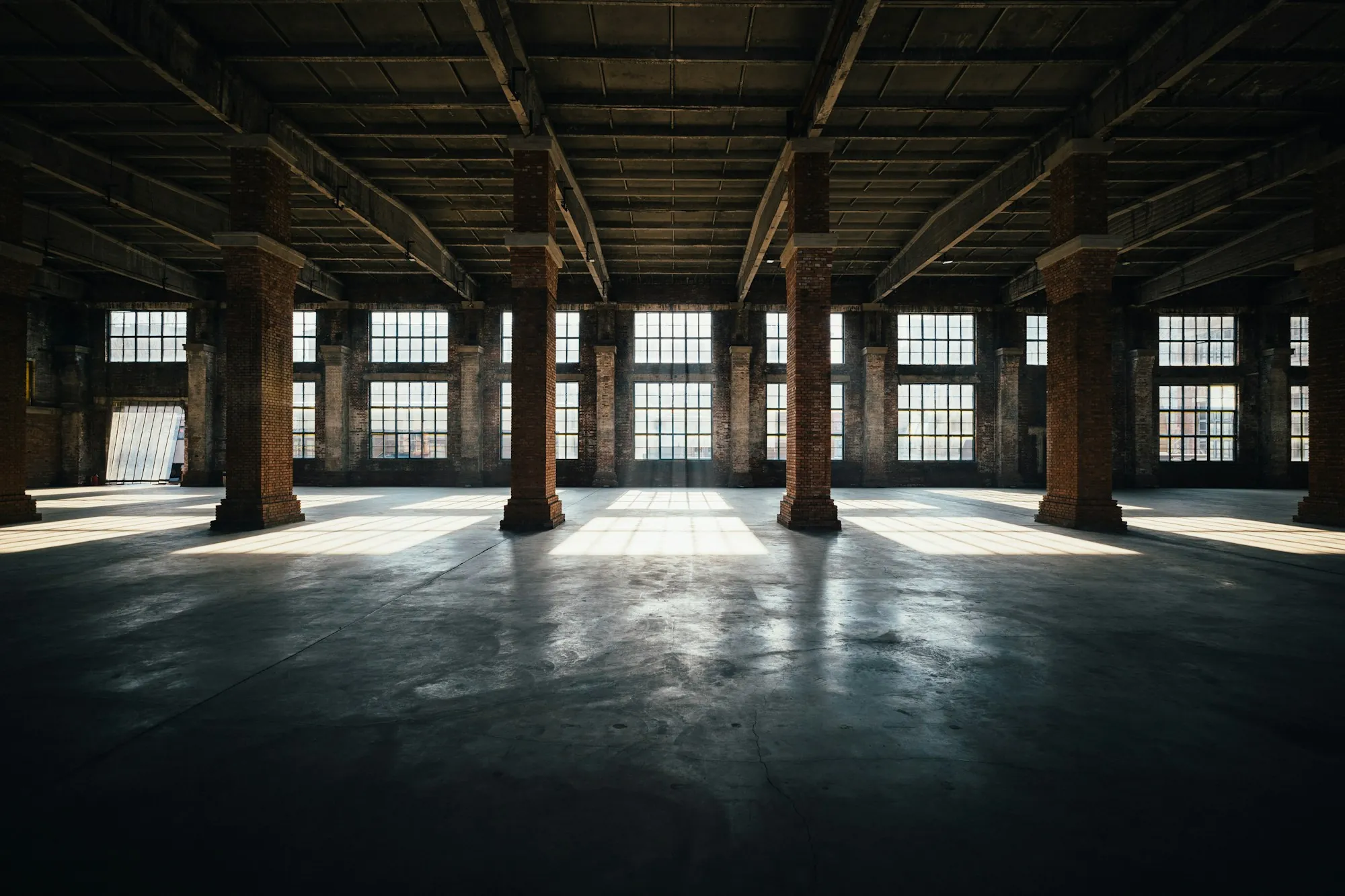 Old industrial hall with a reflective concrete floor